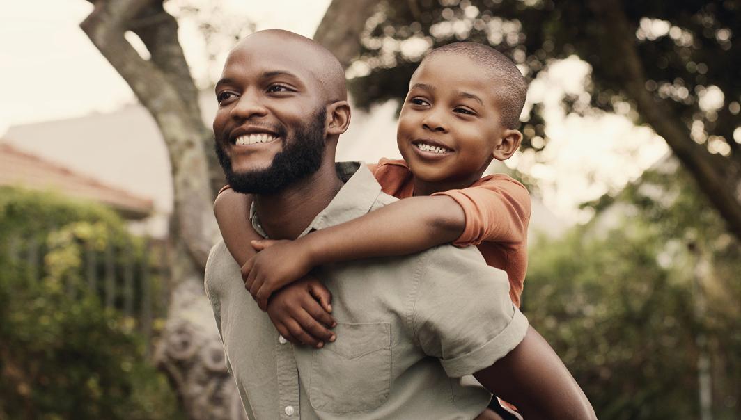 father-son-piggyback-smiling-outdoors.jpg